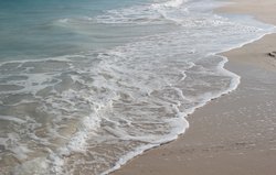 washing sandy shore